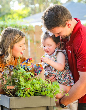 A loving family gardening together using a PopUp Garden. 